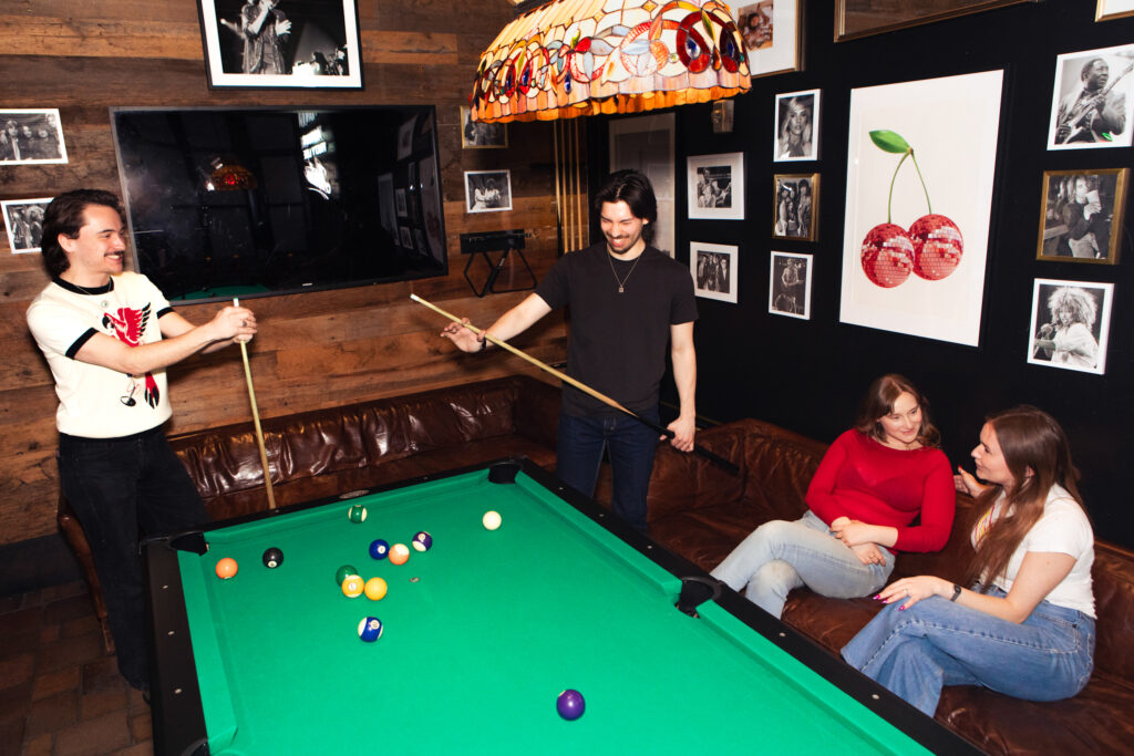 A group enjoys the free pool table at Artie's Backroom